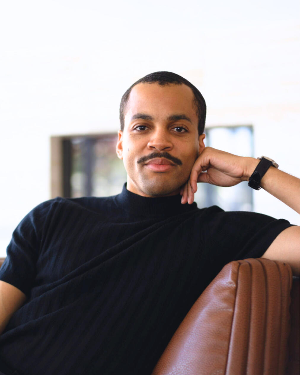 Bryan_Alston_Most_AI_Marketing_Operating_System_of_Tomorrow_Headshot_Indoor_Couch_Black_Shirt_Watch2